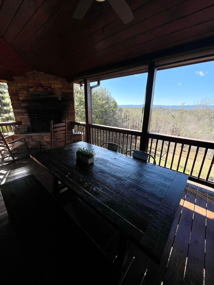 Outdoor wood-burning fireplace and outdoor dining table on the back deck with mountain views!