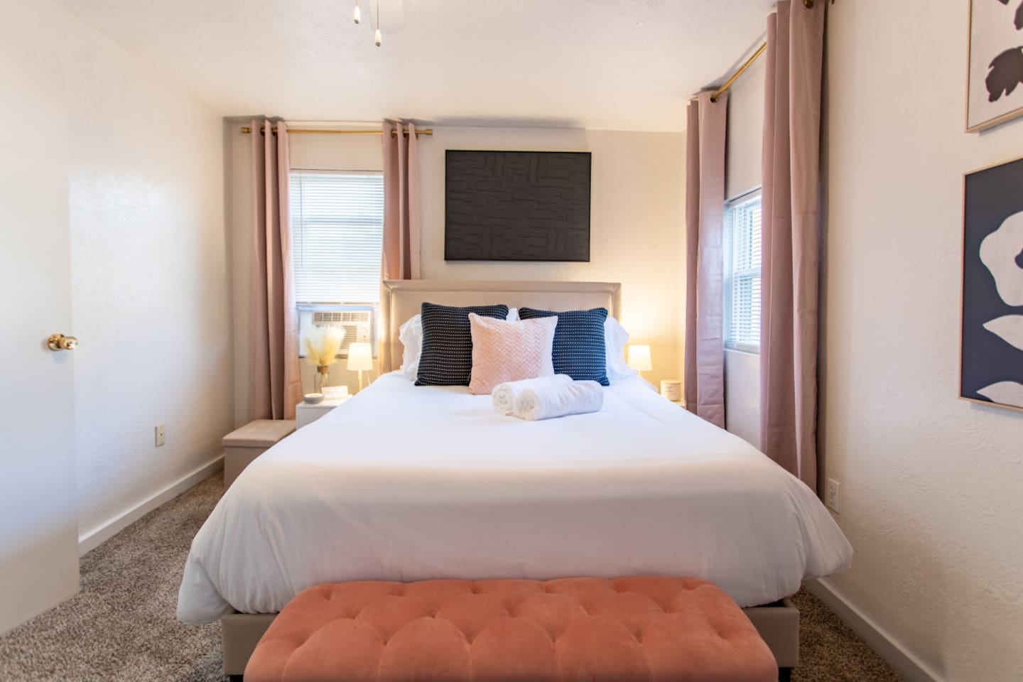 A cozy bedroom with windows on each side, allowing natural light to flood the room and create a bright, airy atmosphere for a peaceful retreat.