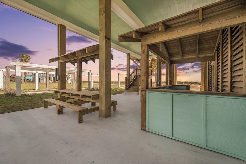 Breezy Point Exterior: Plenty of room for parking, storage, or setting up outdoor activities, all under a protective roof.