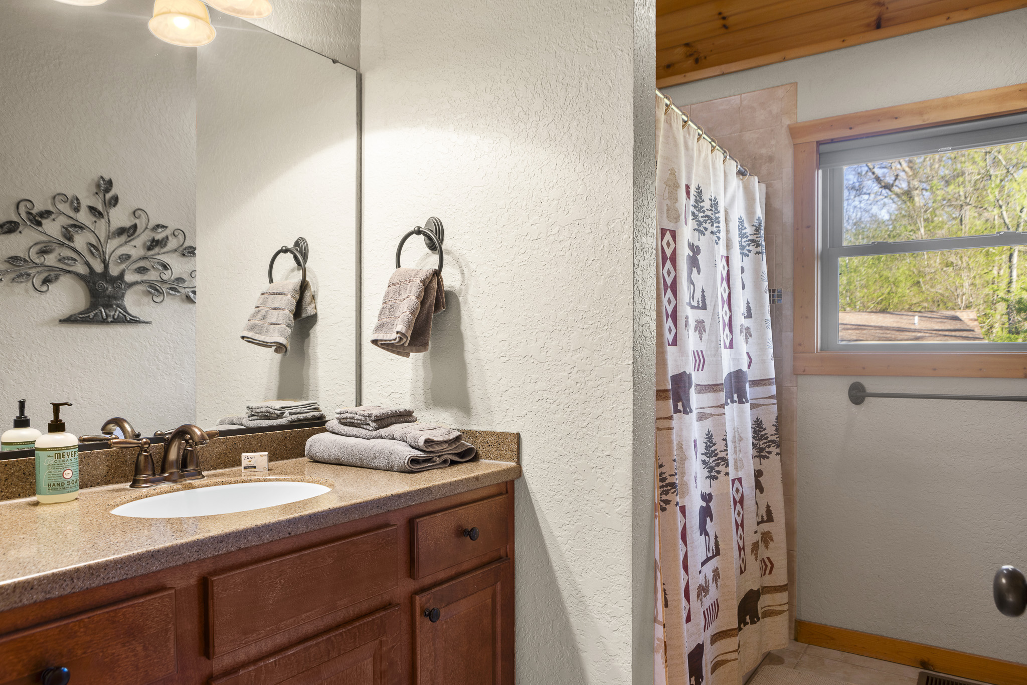 Bathroom Retreat: Relax in this stylish bathroom with nature-themed decor and natural light!

