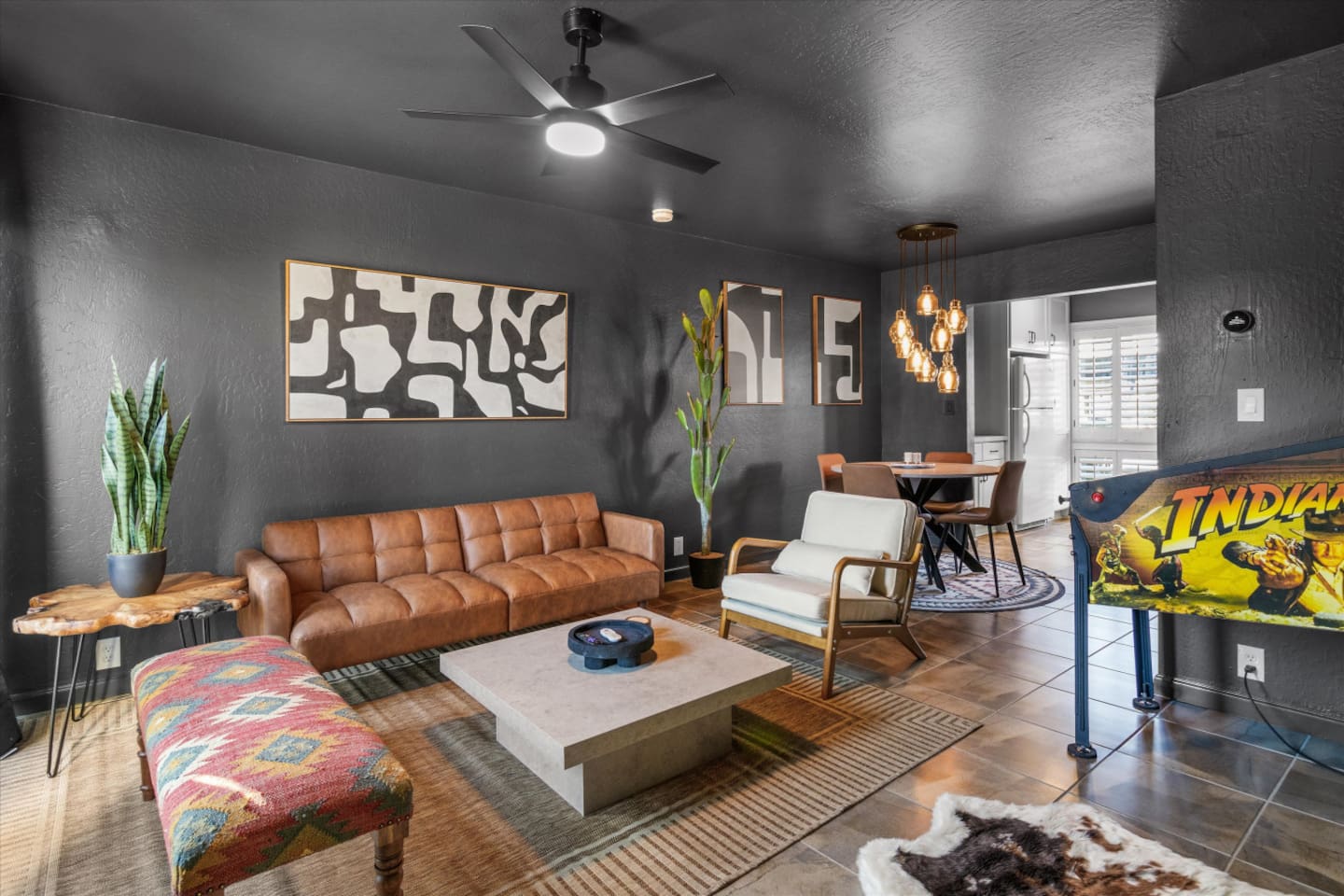 Living room with fun pinball game, and a relaxed spot to hang out.