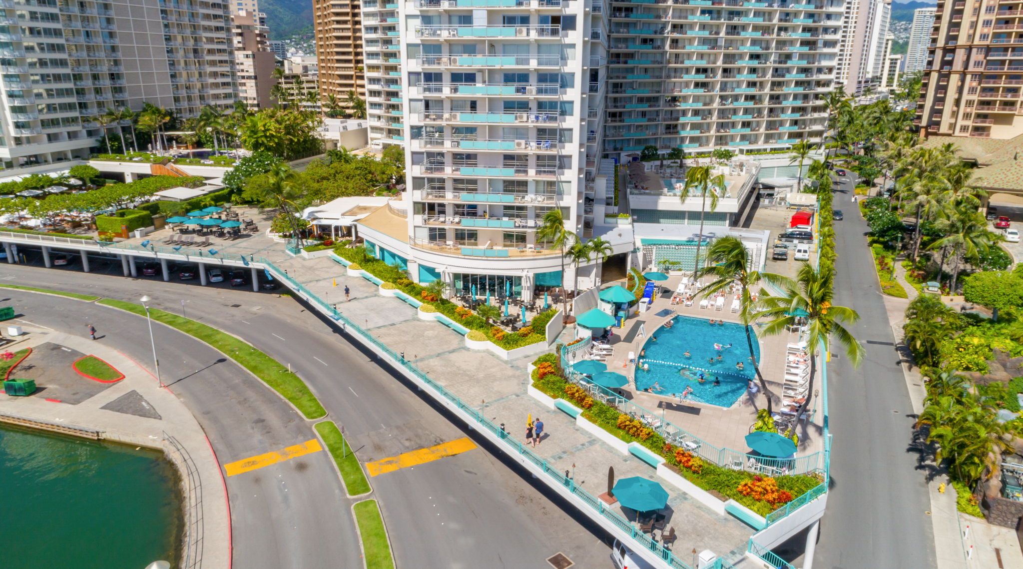Aerial view of the Ilikai Hotel back area showing the promenade that leads to the beach as well as the hotel pool on the lobby deck