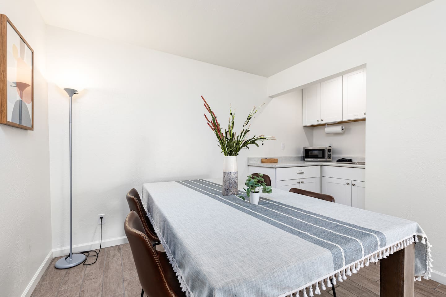 With sleek seating, geometric artwork, and a linen runner, this space is designed for both comfort and style.

