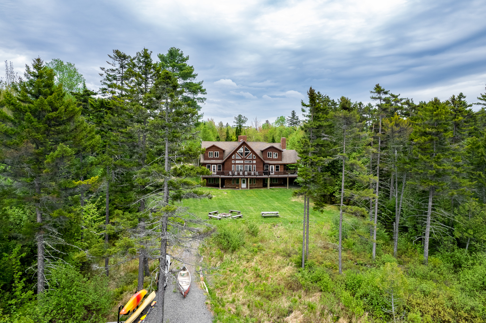 Escape to the back yard overlooking beautiful Lily Bay with amazing sunsets. Play a game of corn hole, gather by a crackling fire with 2 fire pits, use 2 kayaks and 2 paddle boards, or lounge by the your private dock and read a book.