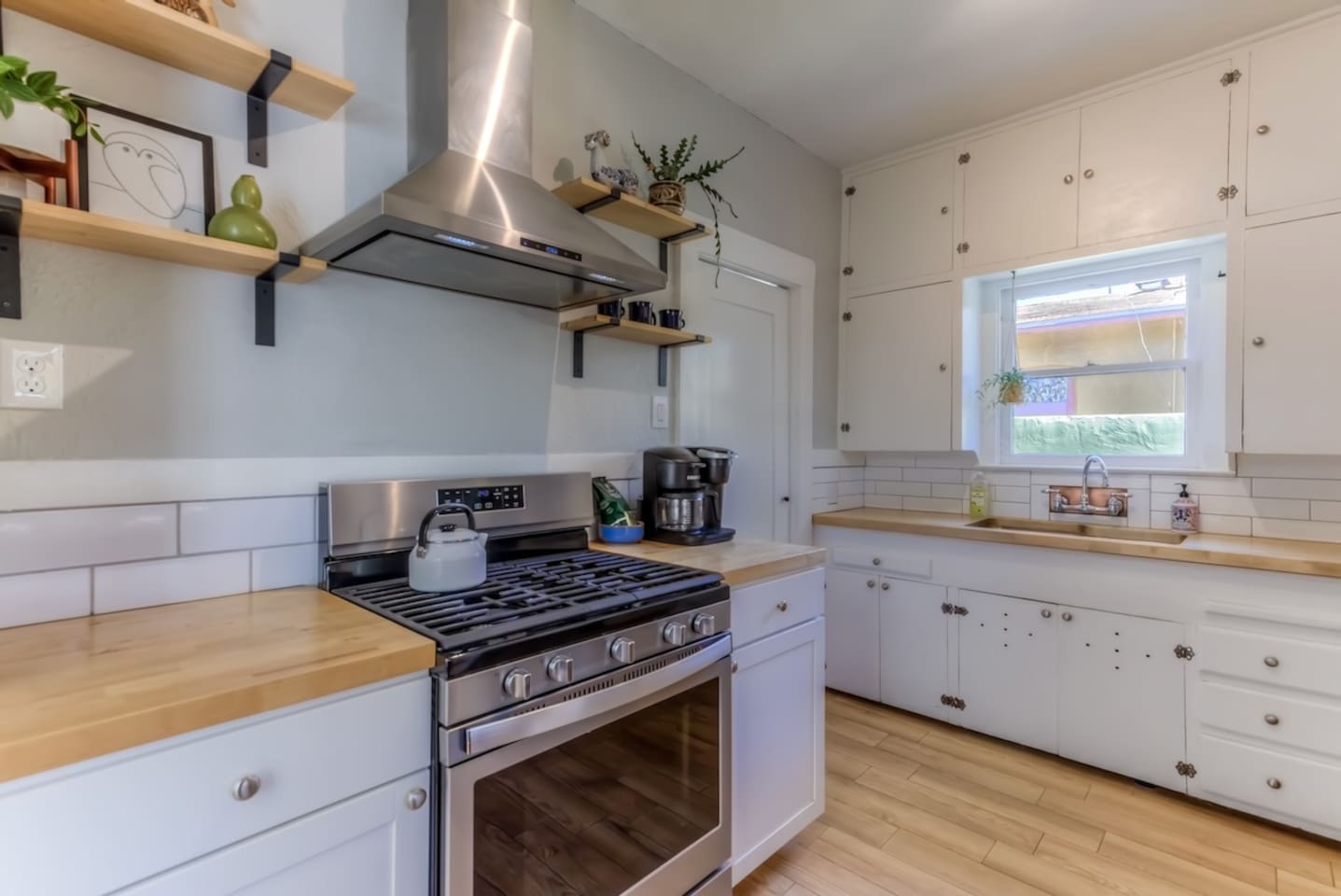 newer stove with pots and pans and cooking utensils