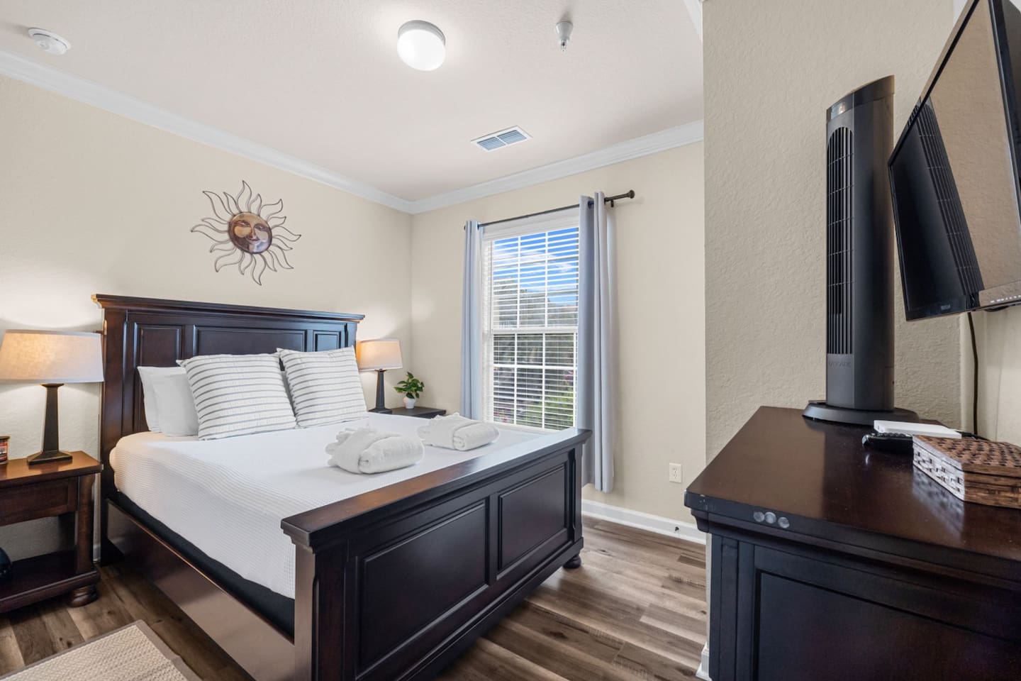 Bedroom 2 with a beautiful queen bed and large windows to let the sunlight in.