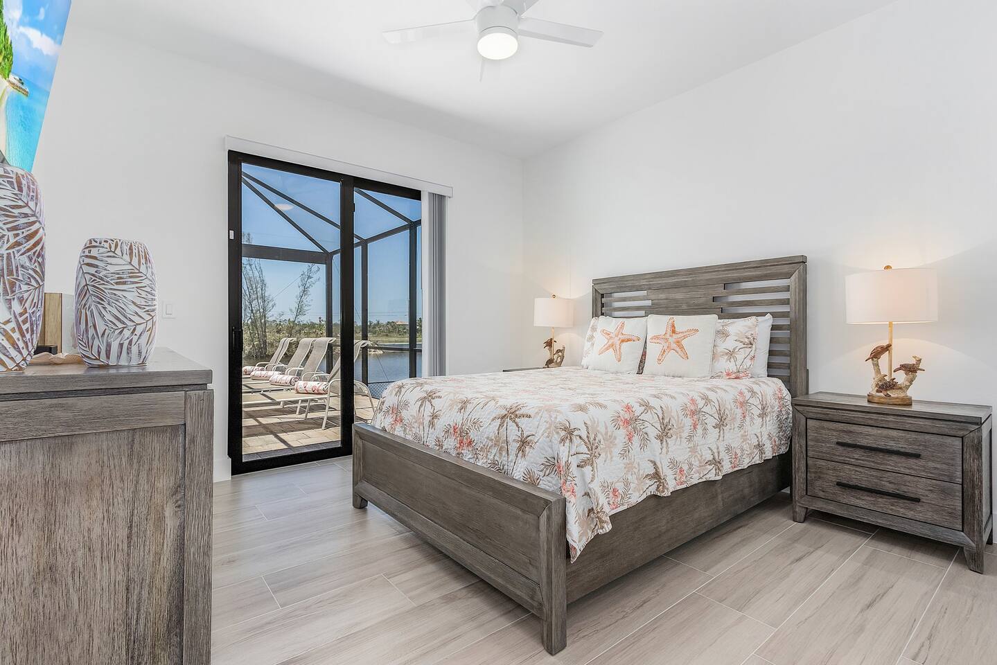 1st Guest bedroom (Queen size) featuring a TV and convenient access to the pool and lanai area!