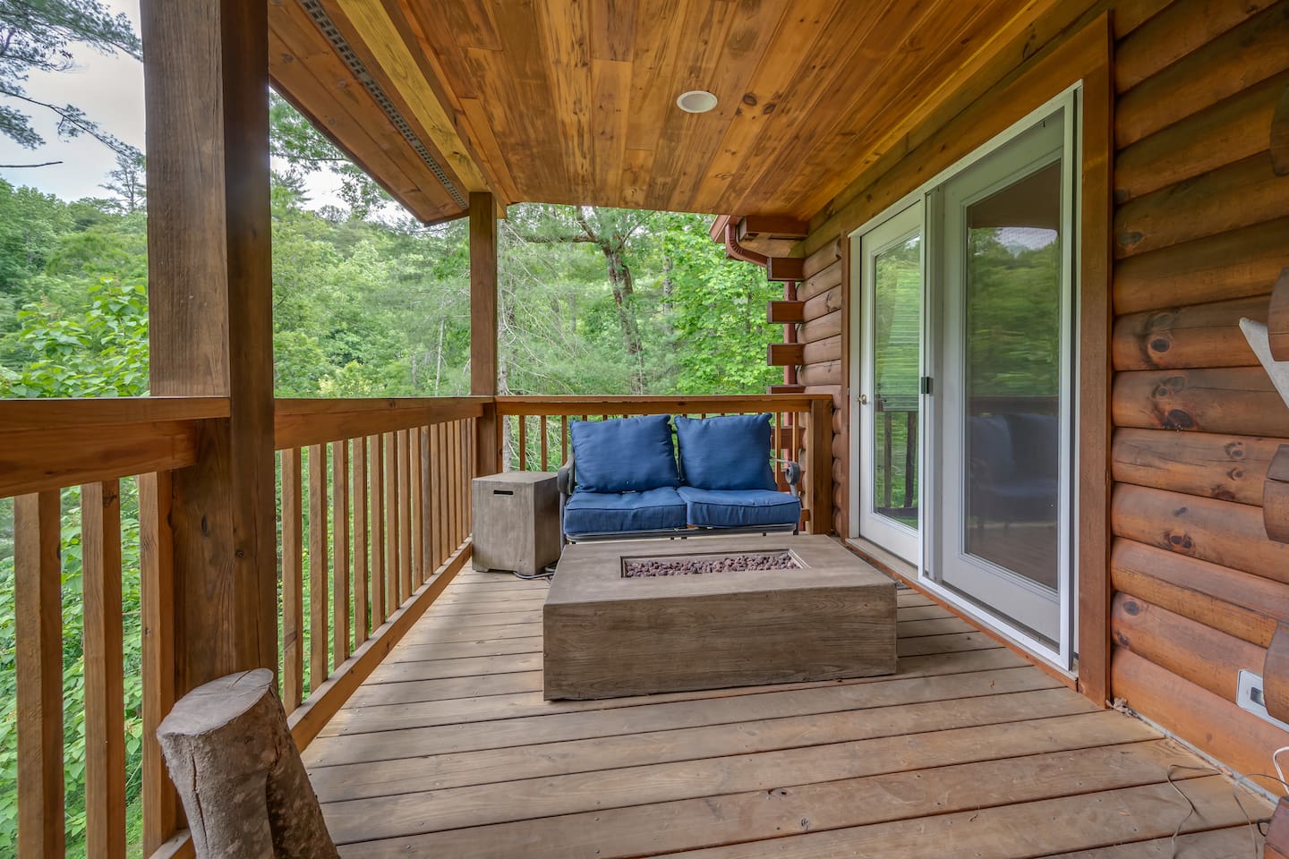 Lower level deck overlooking river with firepit