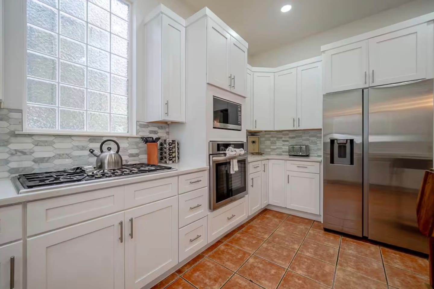 Gas stove and stainless appliances in the newly remodeled kitchen