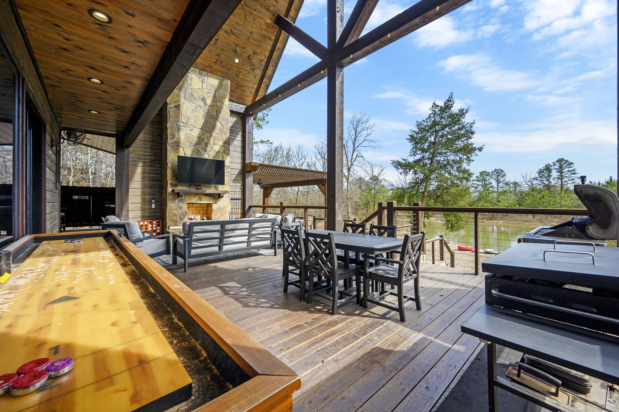 Take the fun outdoors with a friendly round of shuffleboard on the covered deck—fresh air, forest views, and a little friendly competition make the perfect combo.