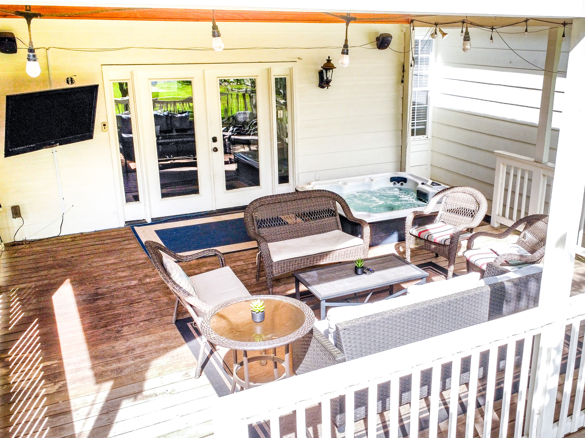 Covered deck with hot tub and TV