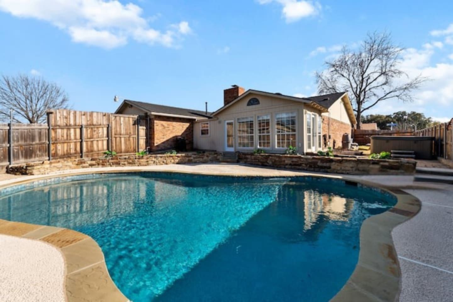 Private backyard oasis with sparkling pool, sun loungers, and direct access to the indoor bar—perfect for poolside entertaining.