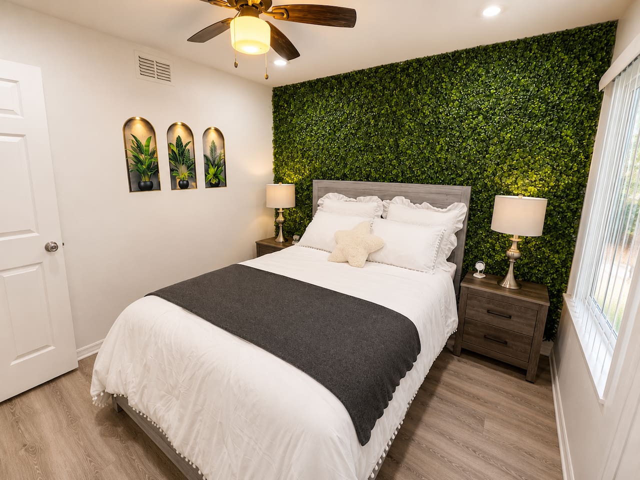 Inviting queen bedroom with a lush greenery-inspired accent wall.