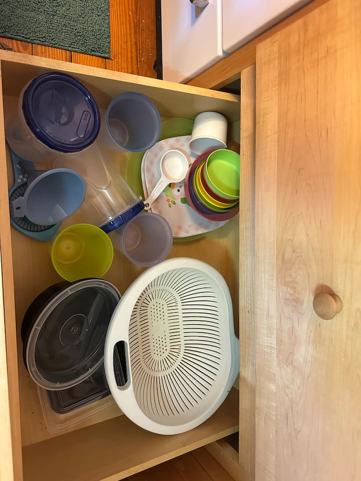 Fully stocked kitchen with everything you need—cookware, utensils, dishware, and coffee maker. Compact yet efficient, ready for cooking meals or enjoying takeout with ease.