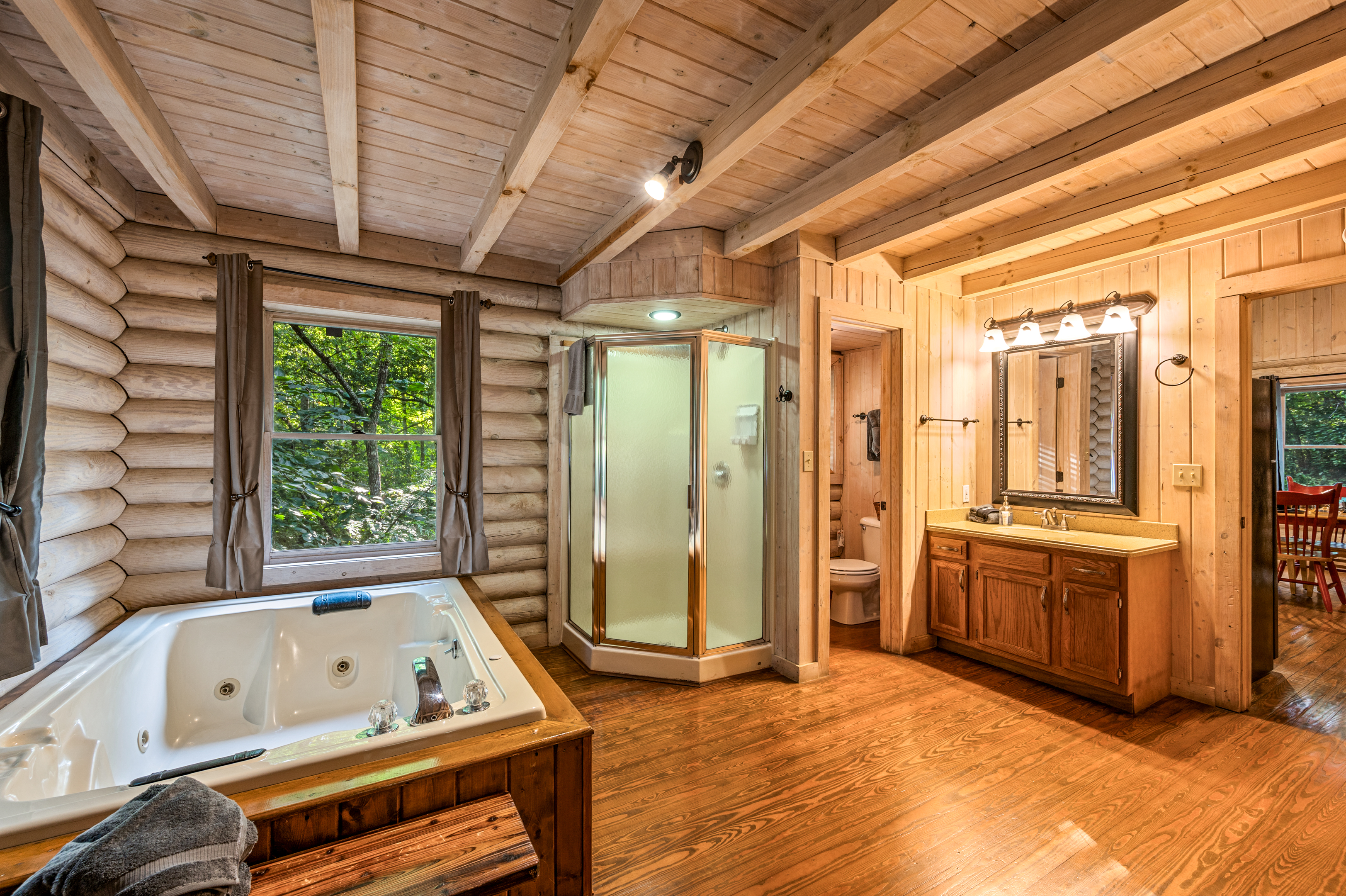 Relax in your jetted tub and shower in this cozy Mountain cabin bath.