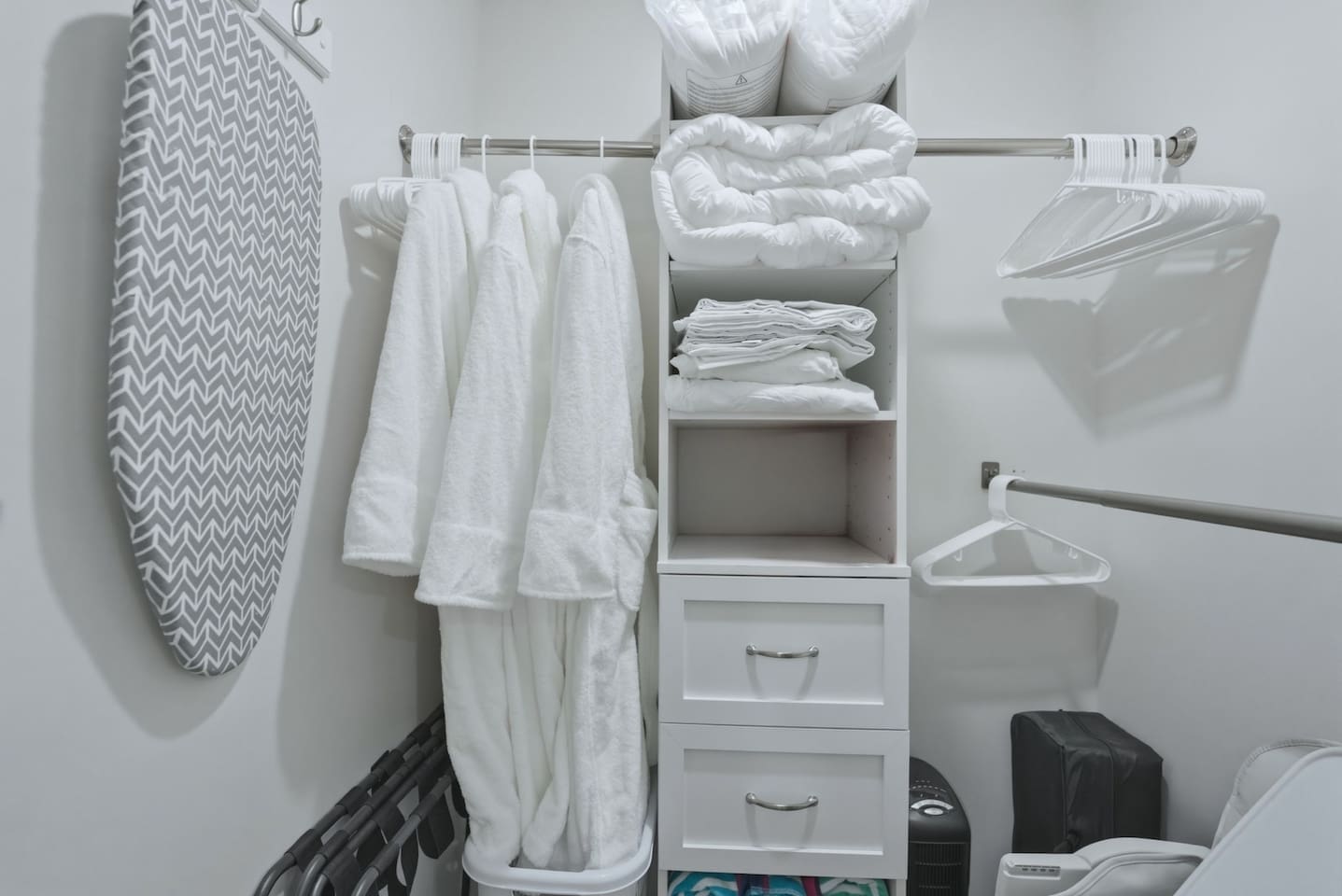 Walk-in closet stocked with hangers, extra linens, pillows, and a laundry basket to keep your stay organized and comfortable.