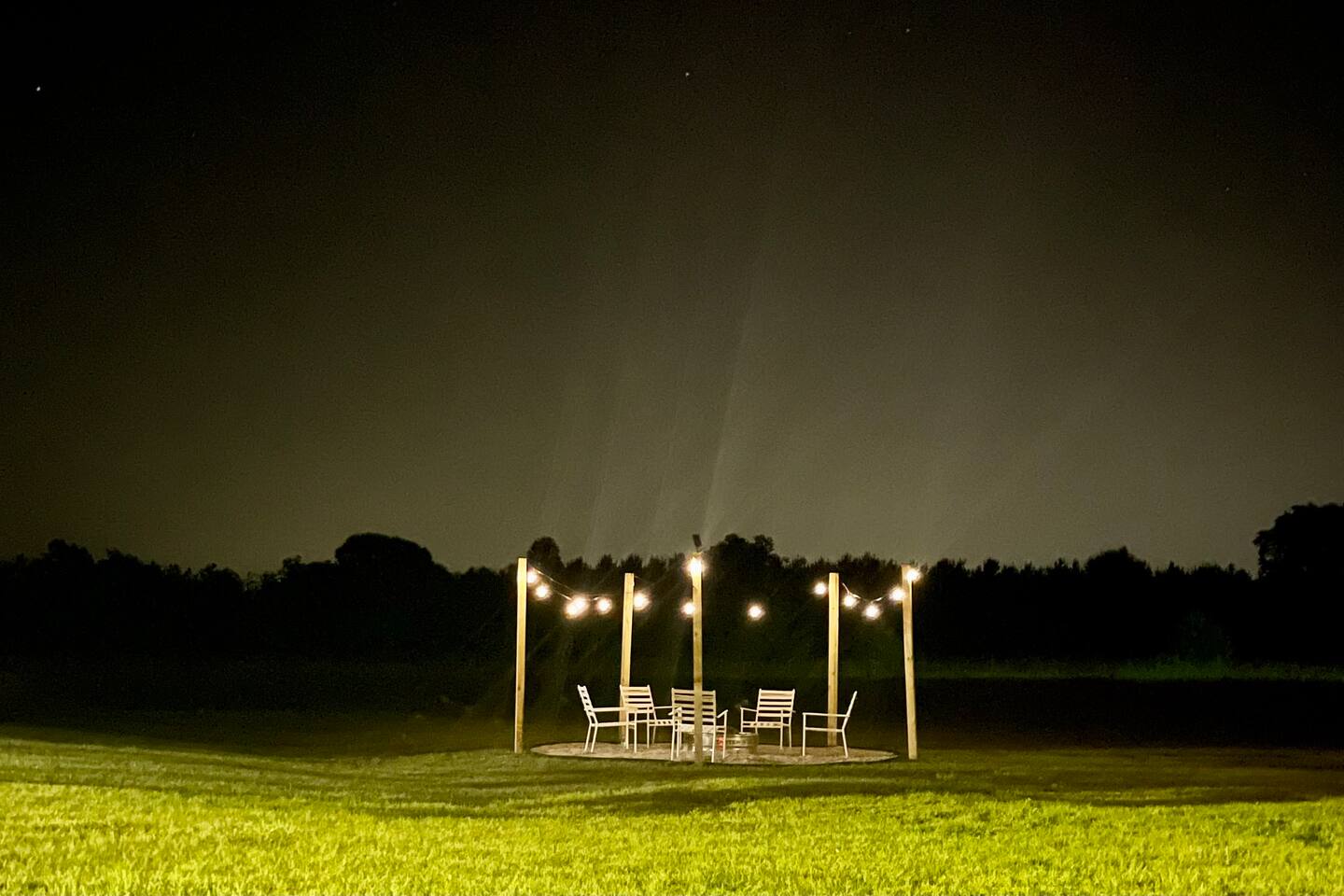 Fire pit lit under the night sky