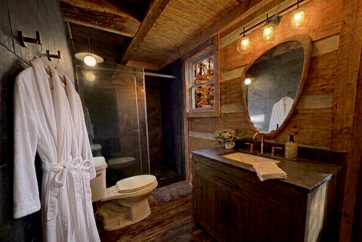 New, spa-like primary bathroom with walk in shower and vanity brings a luxury feel to your mountain escape.