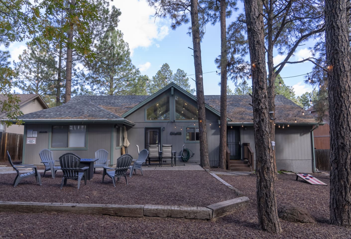 Outdoor space with pine trees, seating, and a peaceful setup for evenings outside.