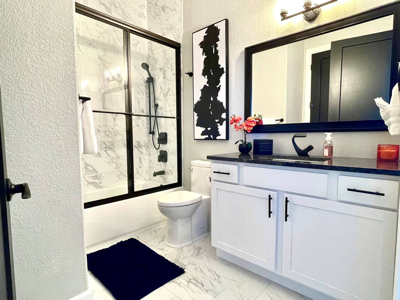Second King bedroom’s luxury bathroom and hallway entrance bathroom. Tub, shower, sink, and toilet. 