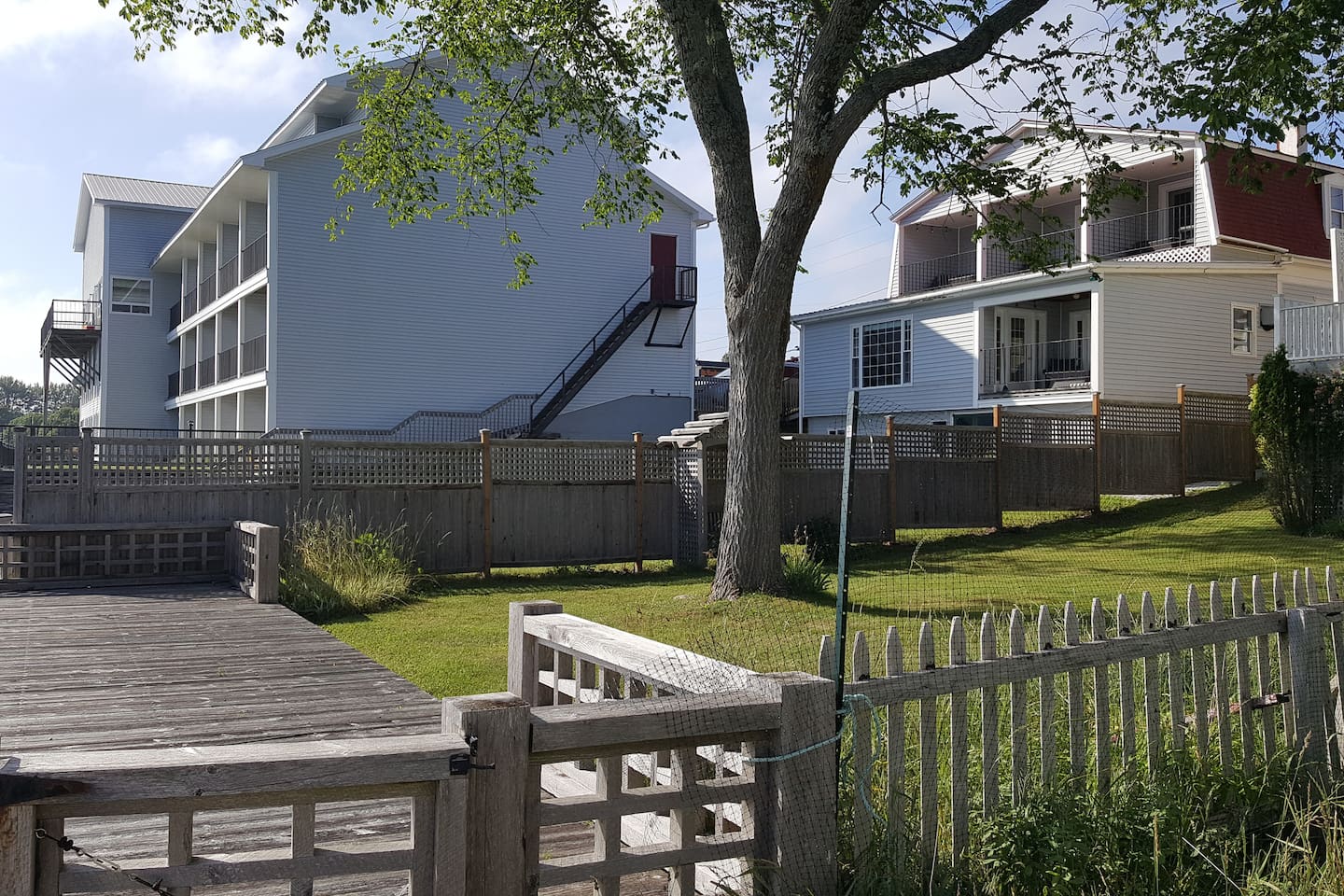 View of the back of the house with private yard and 4 private balcony's.