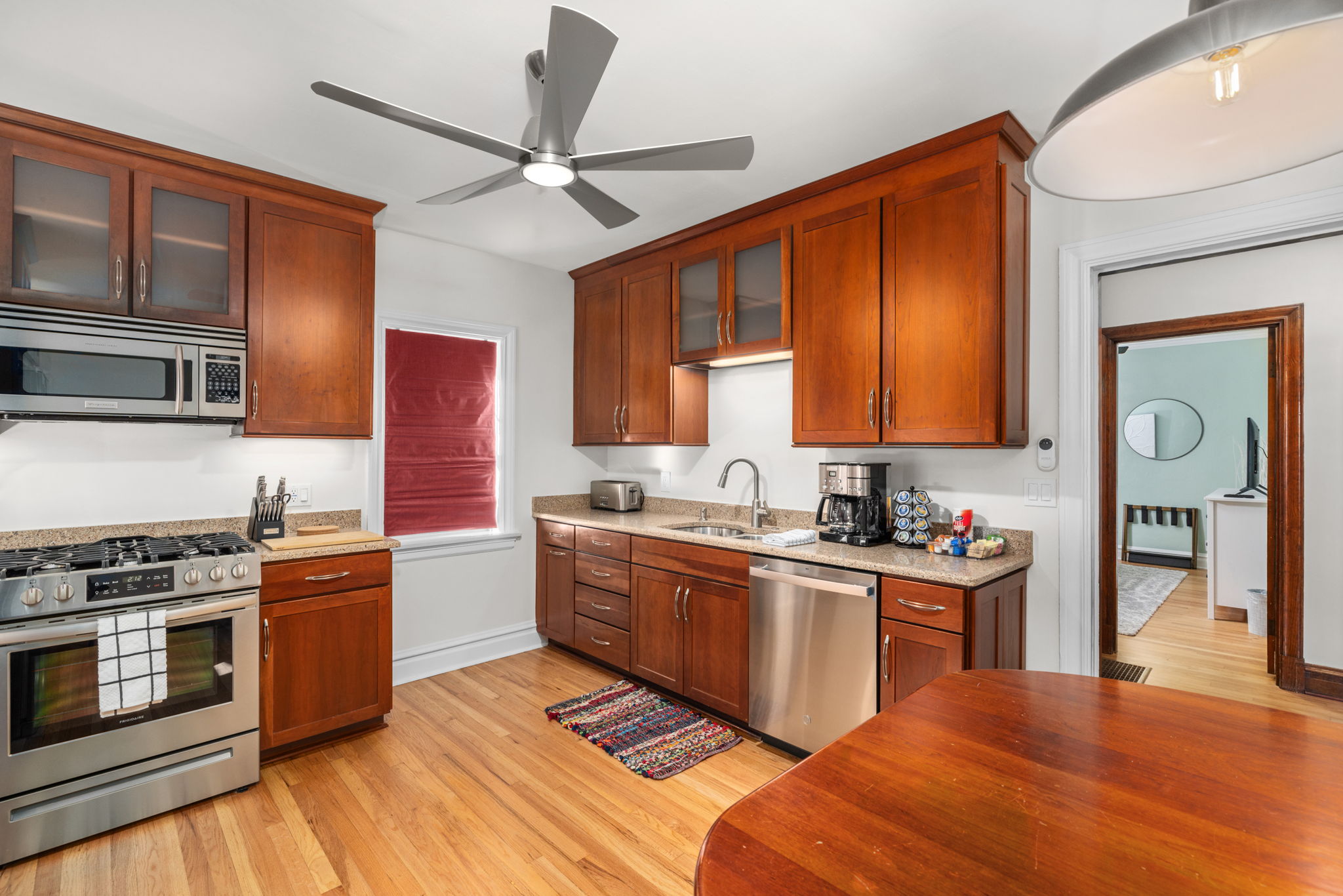 Kitchen with gas range, microwave, dishwasher, full kitchen utensils, plates, bowls, (kids cups and dishes), toaster, blender, waffle maker, and cookware.  Additional dining space for 4.