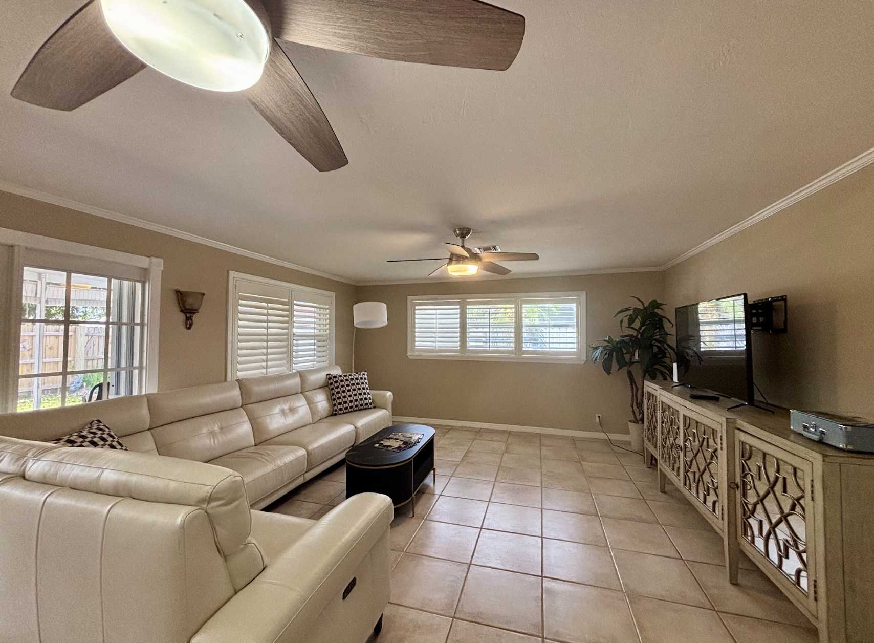 Our expansive rear living room has an abundance of seating and cozy nooks, as well as a comfortable couch with recliners.