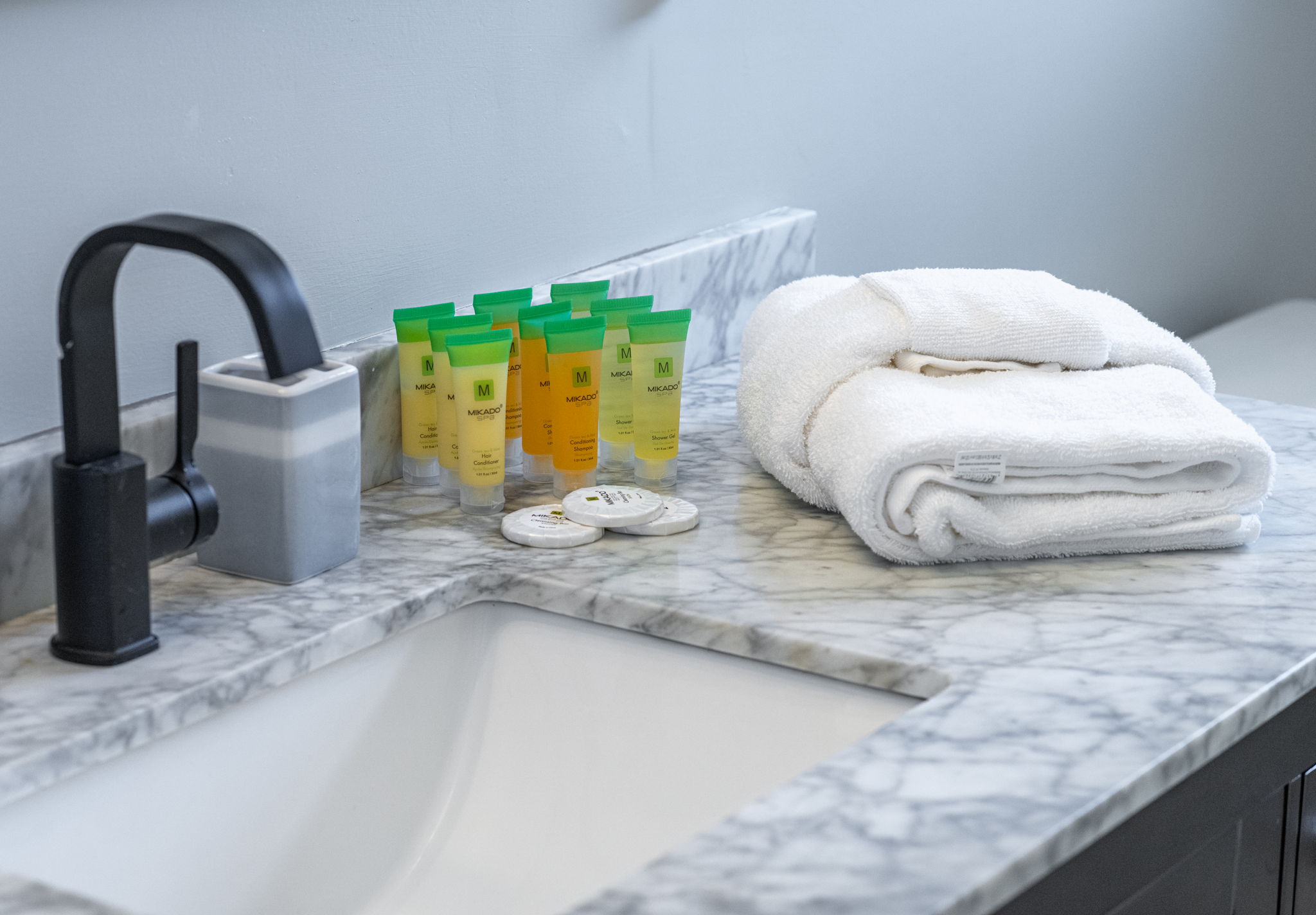 Simple yet inviting, this full bathroom includes a tub and shower combination setup, ample counter space, and a touch of retro character.