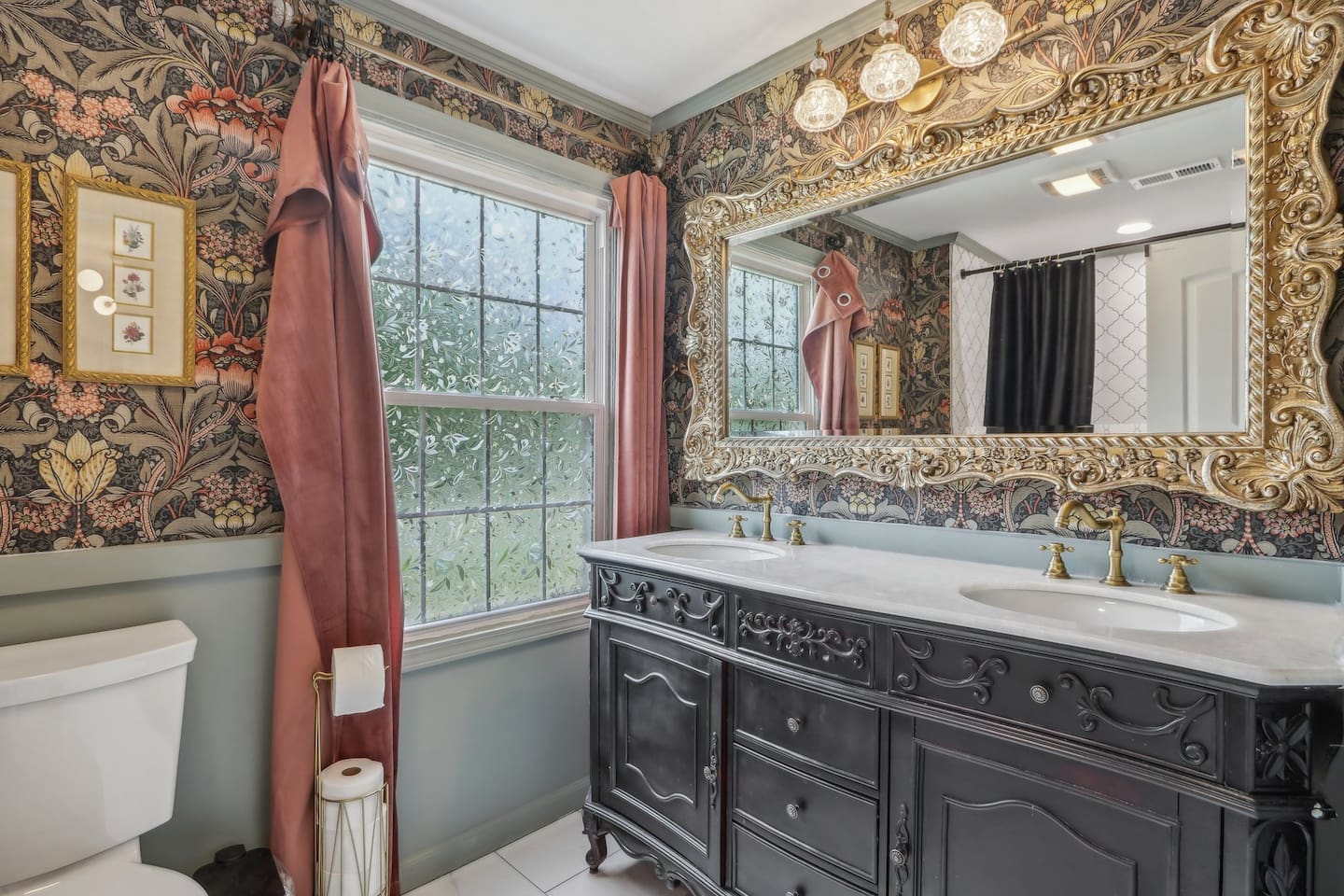 Elegant full bathroom, with a spacious double vanity, ornate mirror, and rich botanical details.