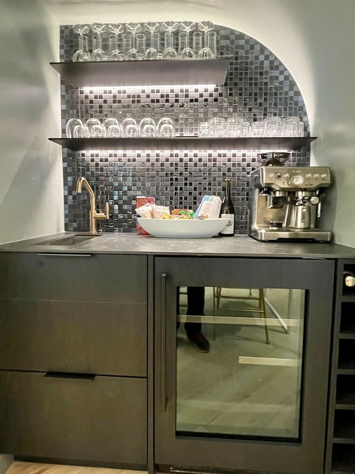 Hot & Cold Beverage Station w/ temp controlled wine & cold drink fridge, Expresso maker, French Press, Drip Coffee Maker, Nespresso, Electric Kettle, bar sink, pantry and really cool LED accented shelving to set just the right vibe