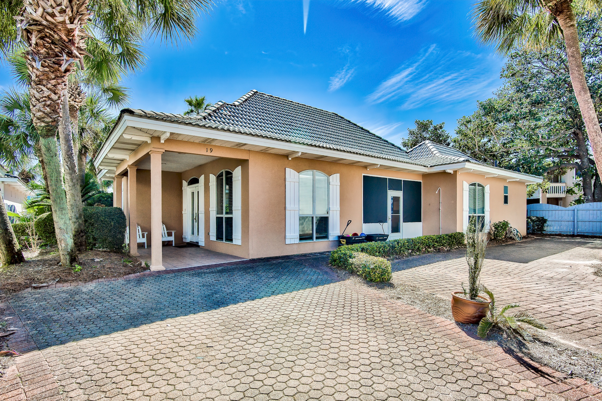 Real Sandy exterior with private driveway and beautifully maintained coastal landscaping