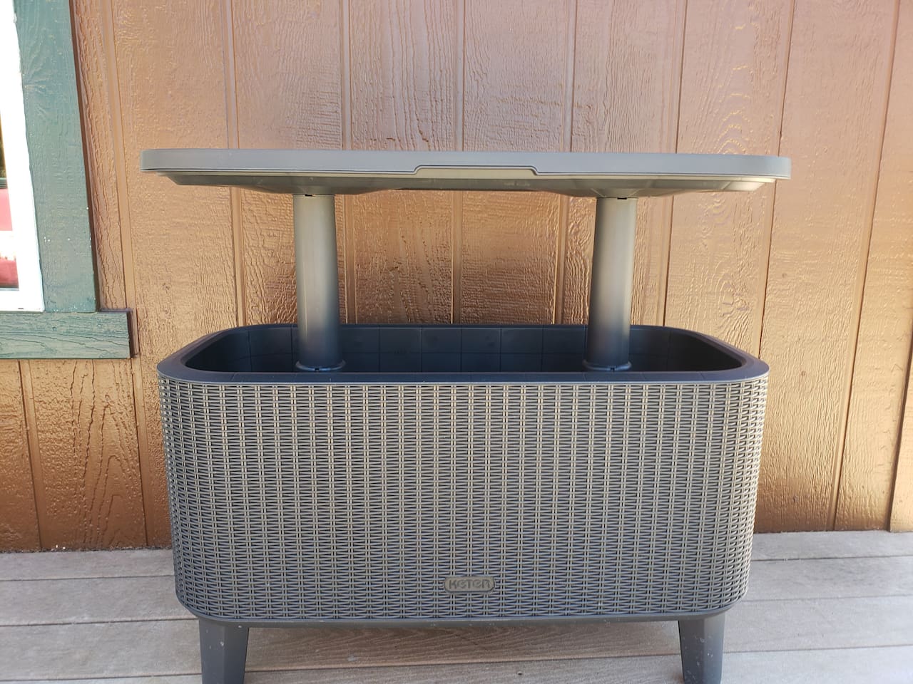 Deck drink cooler with table that raises