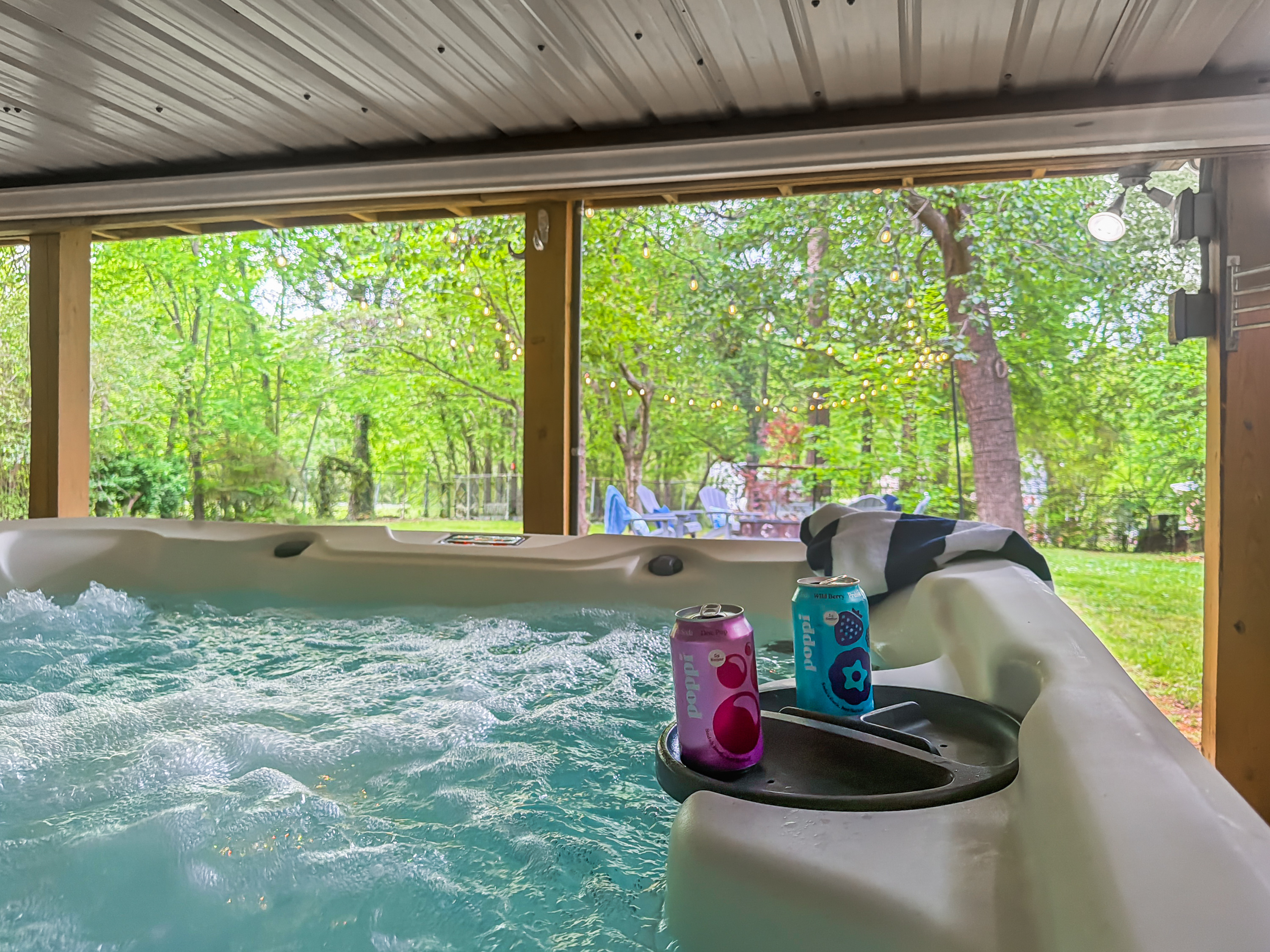 Sink into the hot tub with the trees closing in around you — a cold drink on the rail, the day washing off, and downtown a short walk away when you're ready.