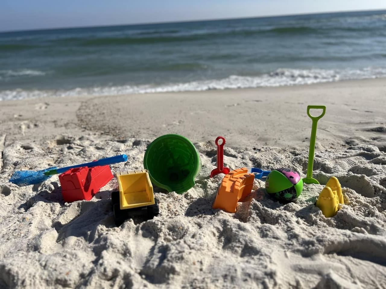 Bright beach day fun with colorful toys, soft sand, and ocean breezes!