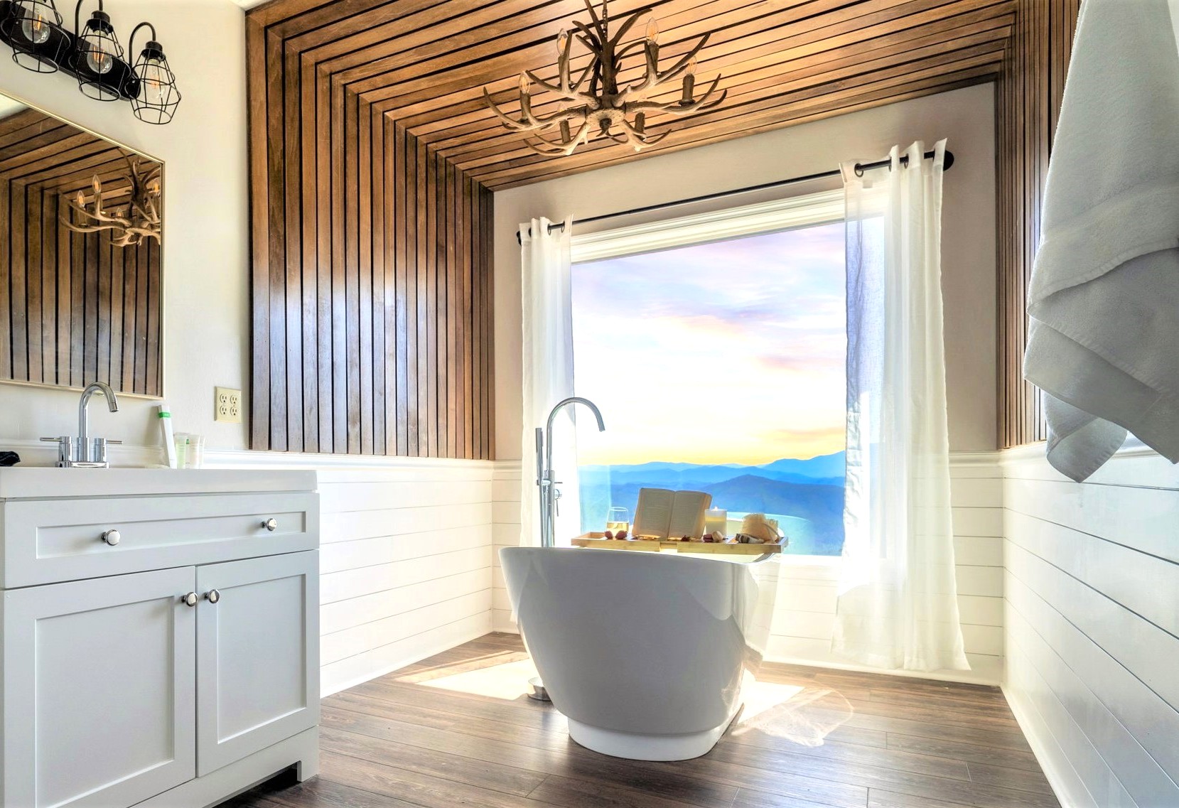 Quite possibly the ONLY cabin in the Smokies that offers a front row seat of THE BREATHTAKING Mountain views from your own freestanding tub. An ensuite bathroom from the upper Master.