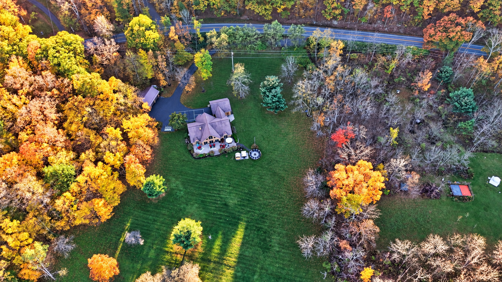 Overhead view of house and surrounding wooded grounds