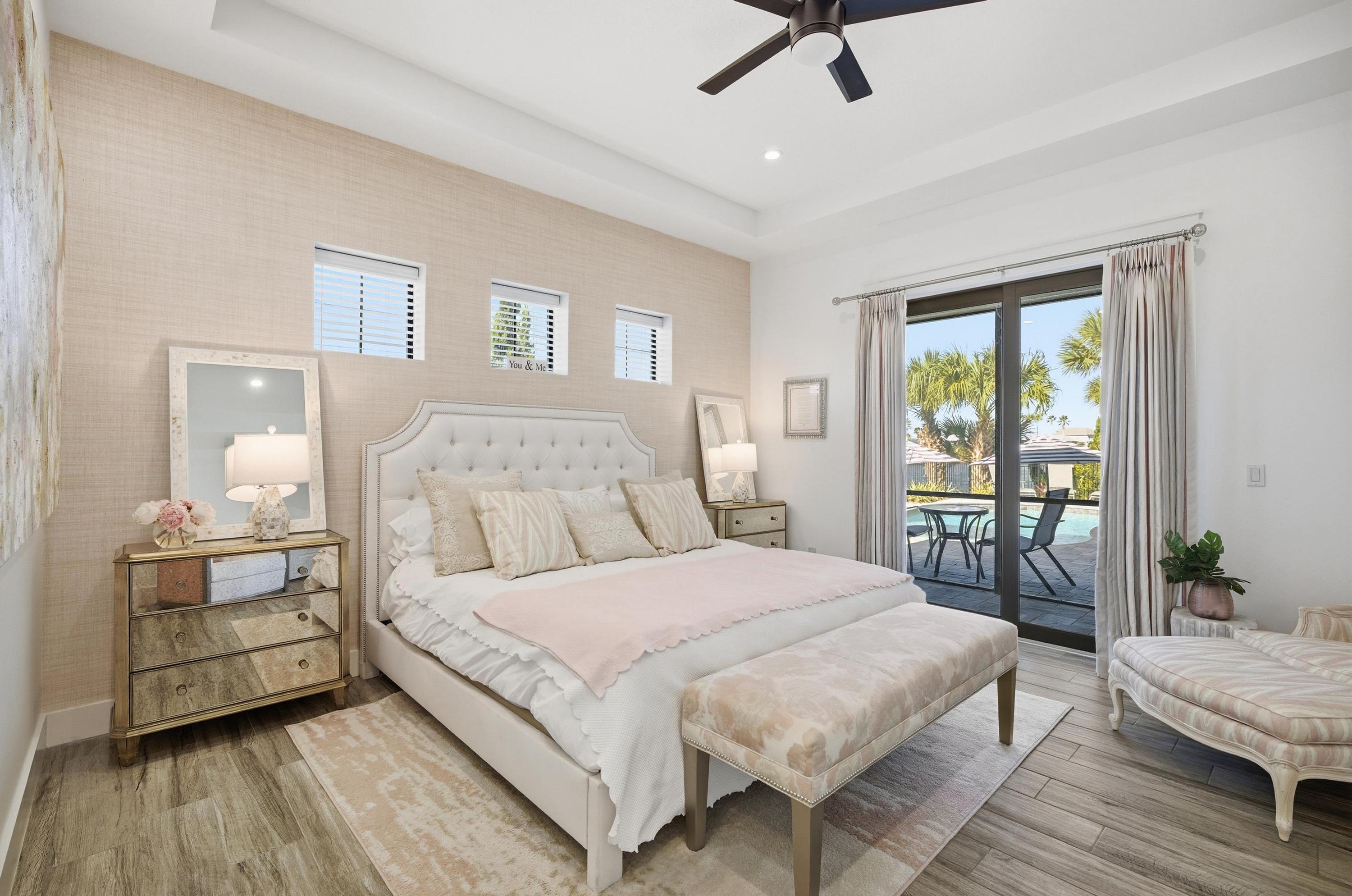 Your private retreat—steps to the pool 🛏️☀️
Unwind in this dreamy primary suite with a plush bed, soft coastal tones, and direct sliding-door access to the patio and pool—wake up, step outside, and let vacation begin.