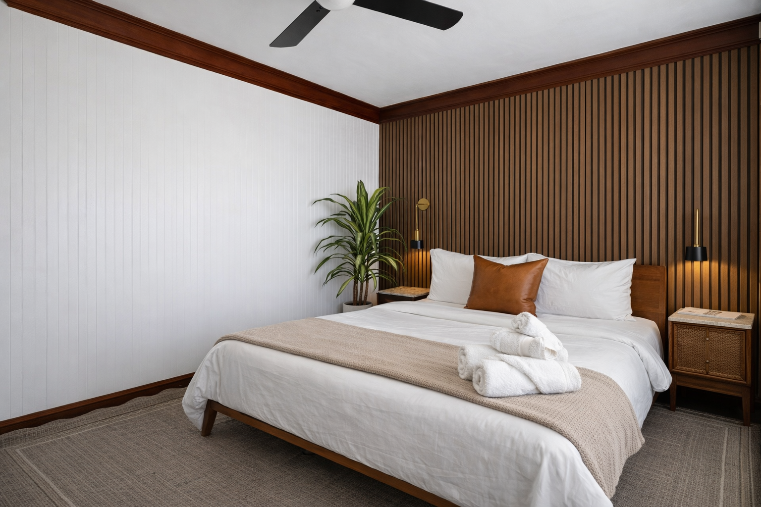Serene King bedroom with warm wood accent wall and hotel-quality linens.