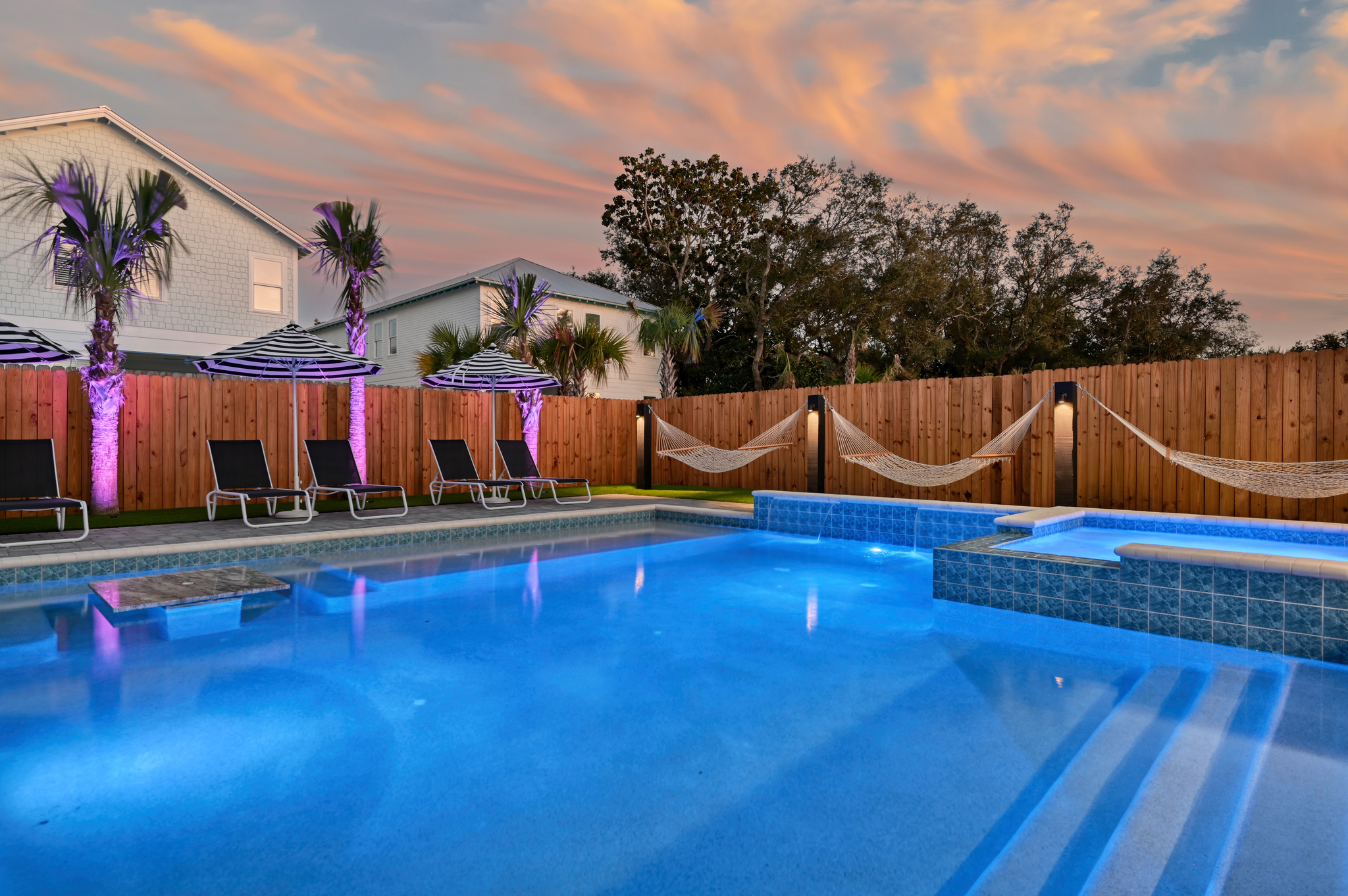 Sensational Resort Pool with a Large Hot Tub, Tanning ledge, Waterfalls, and an In-Pool Dining Table
