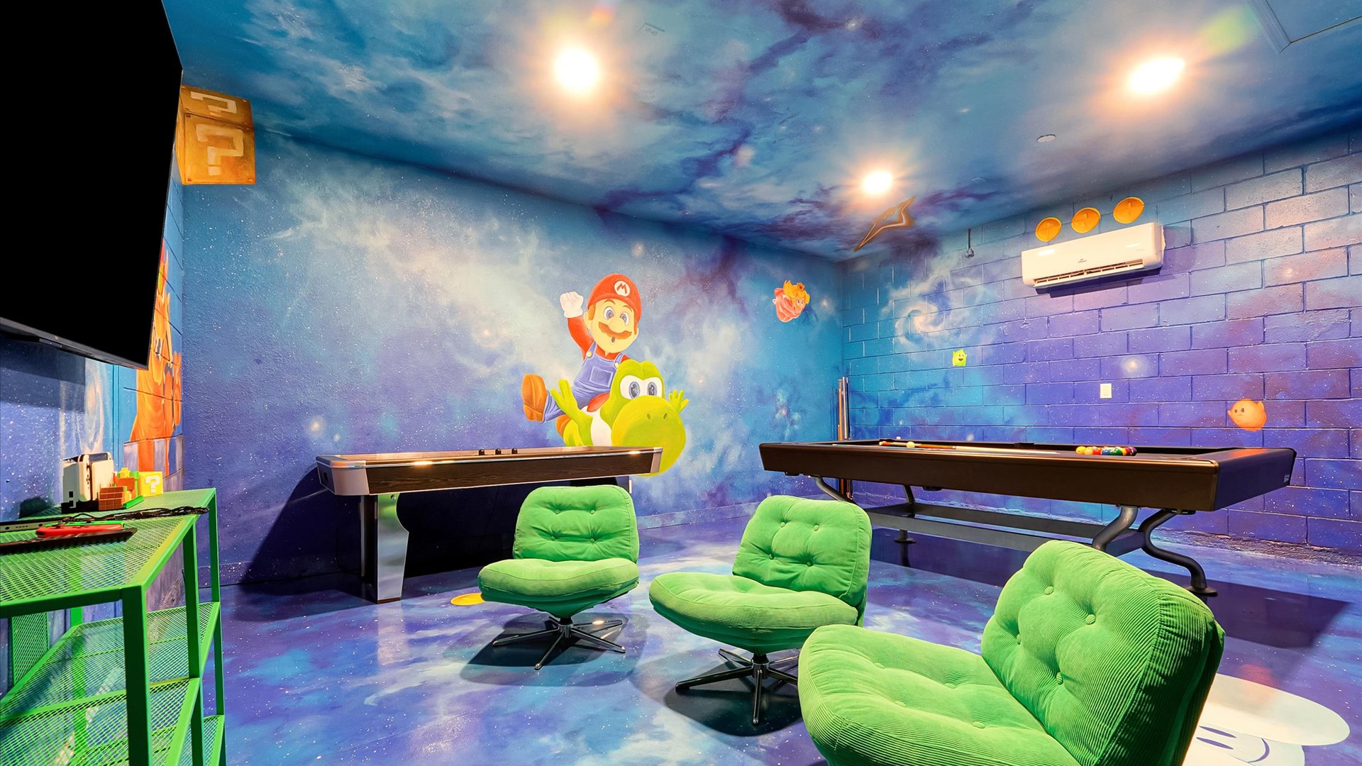 Mario Galaxy Games Room: Comfortable gaming chairs, a large TV, Nintendo Switch, pool table and air hockey offer entertainment for every age.