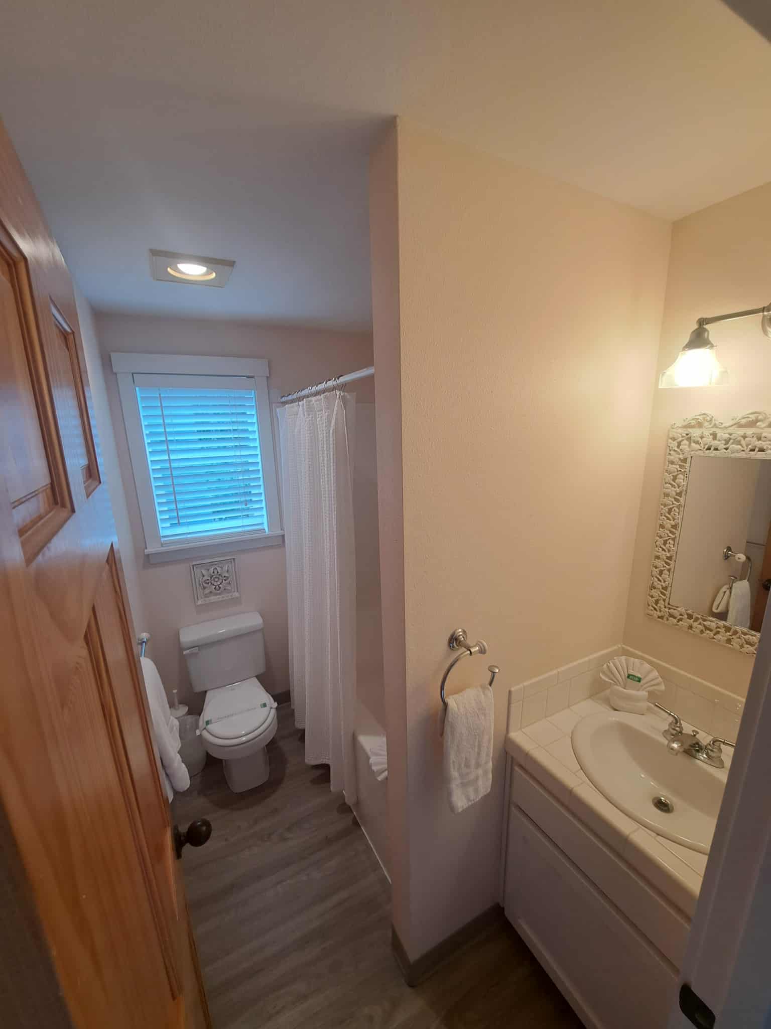 Full bathroom with plenty of soft, white towels.