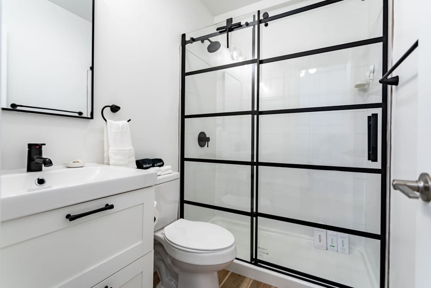 Stylish white and black interior full bathroom, combining modern design with functionality.