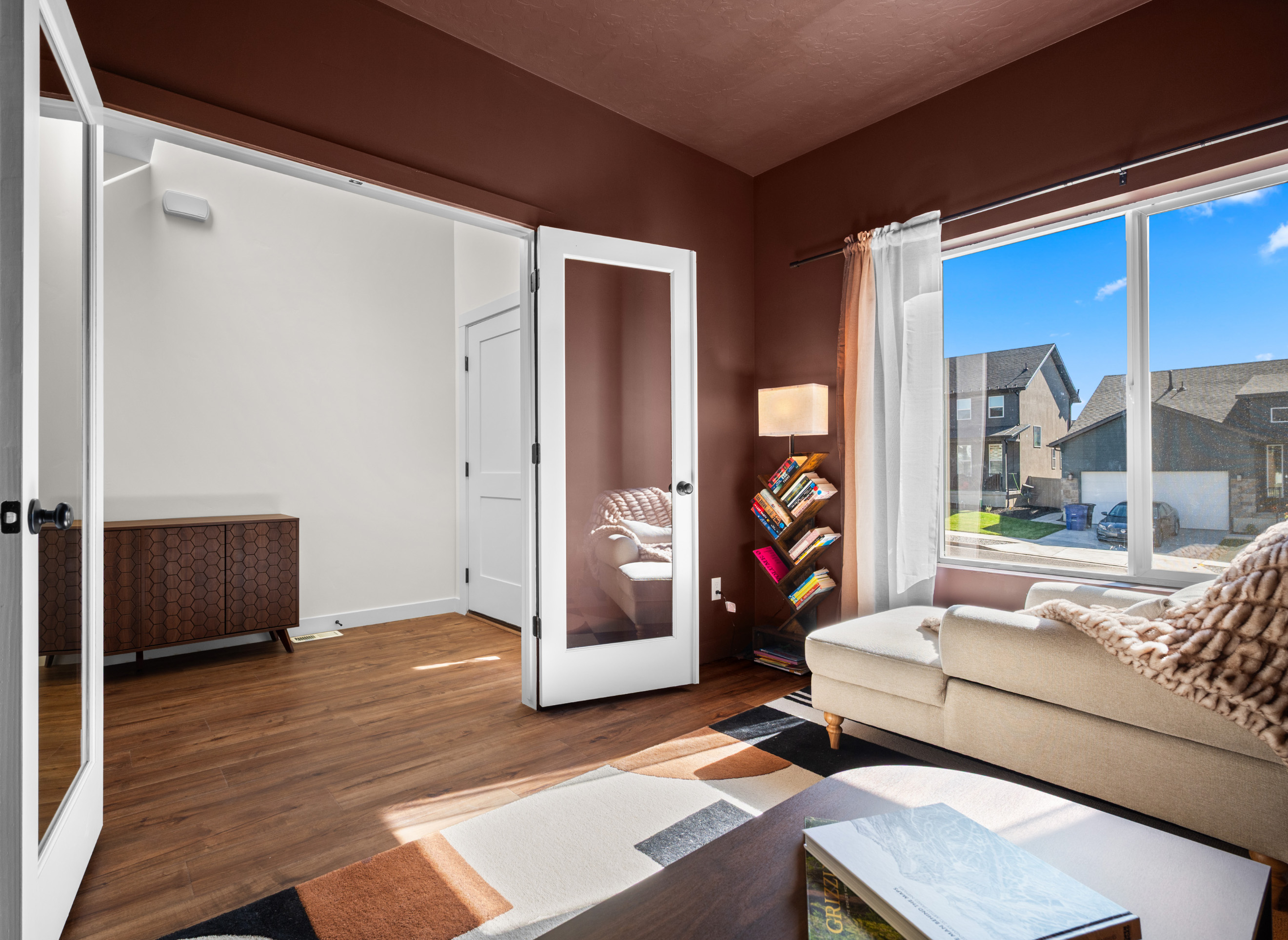 Inviting main-level den with elegant decor and bright windows creating a calm, comfortable retreat.