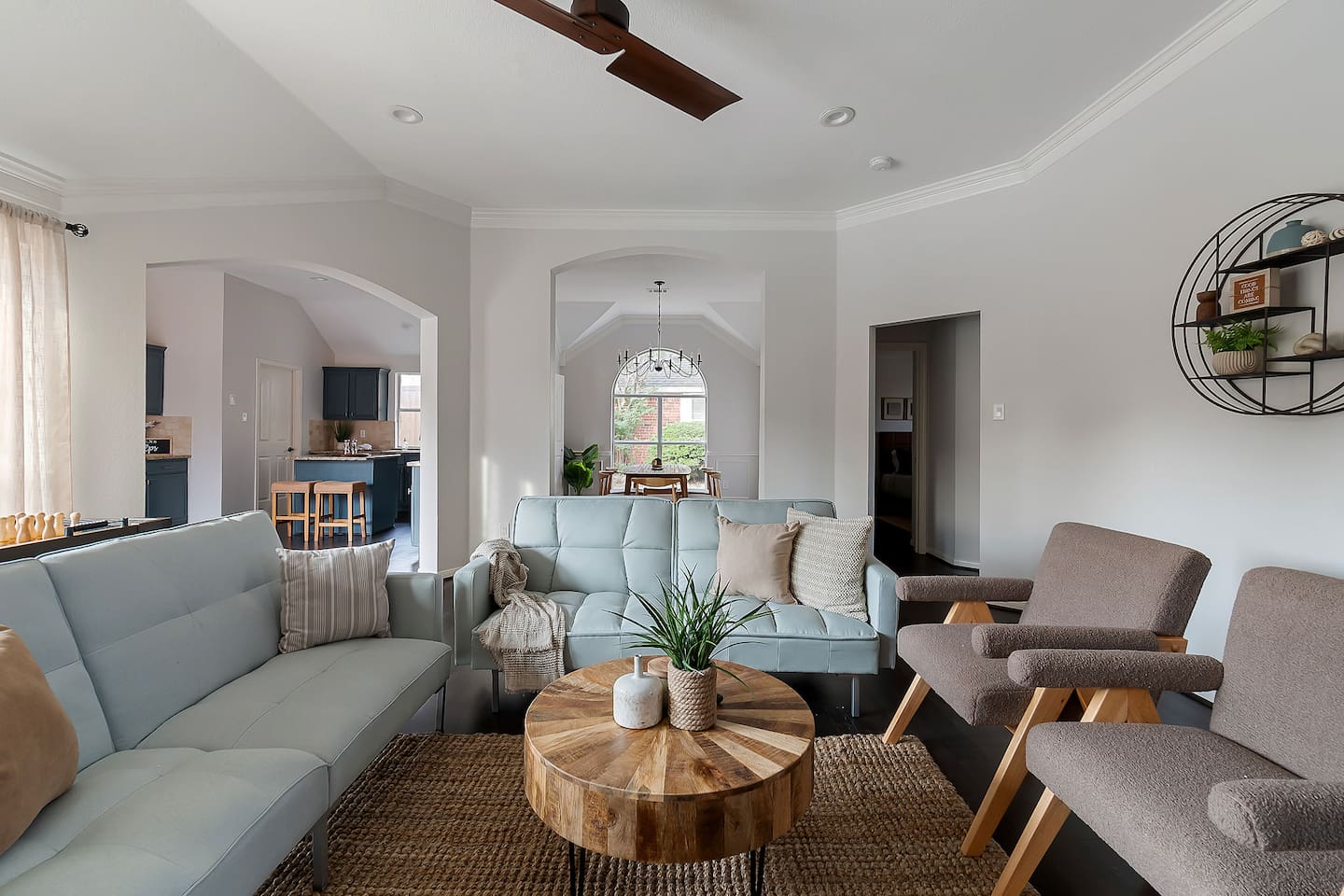 Welcome to our inviting living space with cozy sofas and a sleek TV setup. Shaded windows bring in just the right amount of natural light, creating a perfect balance of comfort and ambiance.