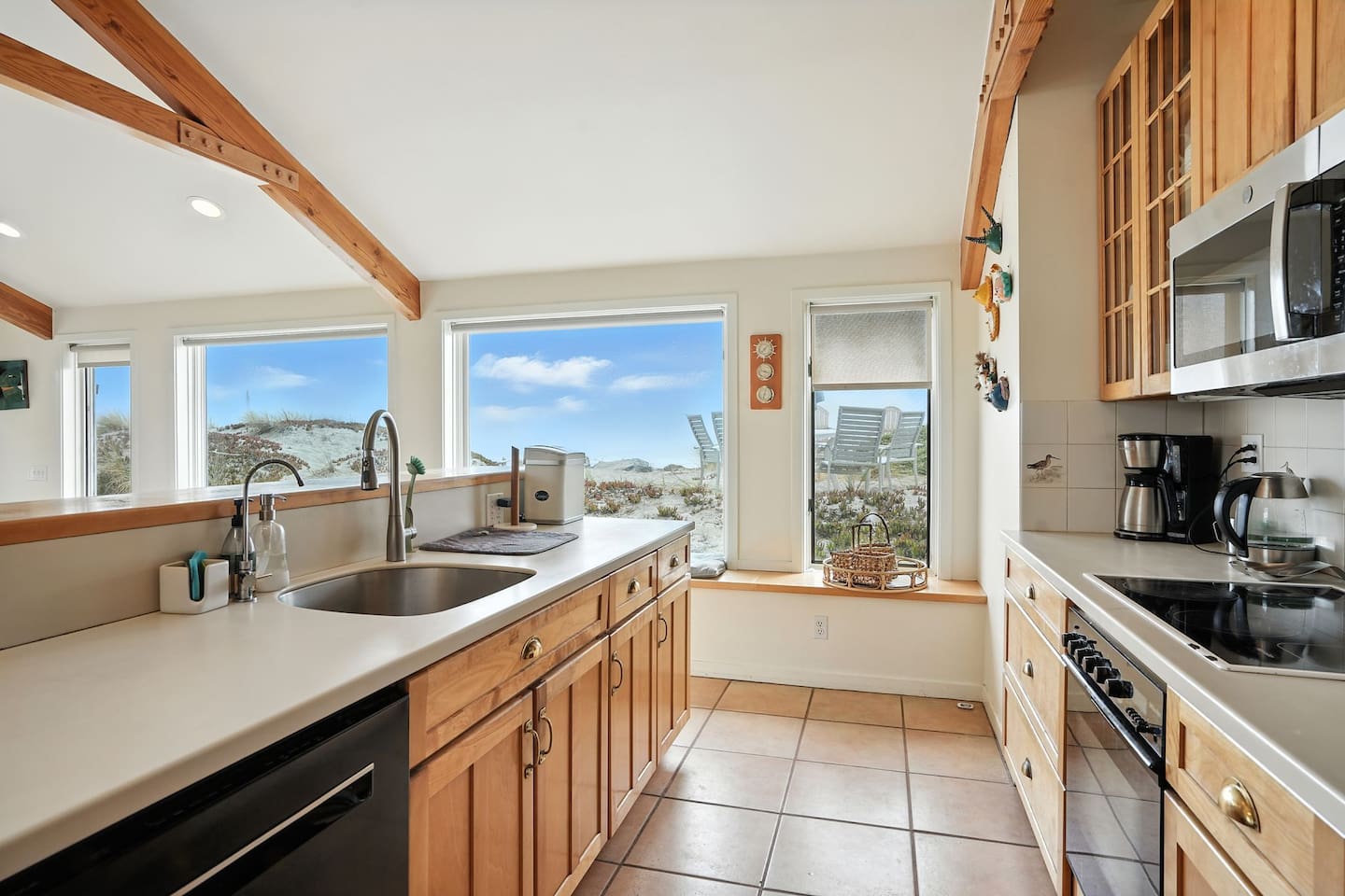 - Spacious kitchen with long counter space and deep sink, ideal for group meal prep  
- Large windows provide natural light and sweeping views of surrounding dunes  
- Fully equipped with modern appliances and wooden cabinetry for warmth