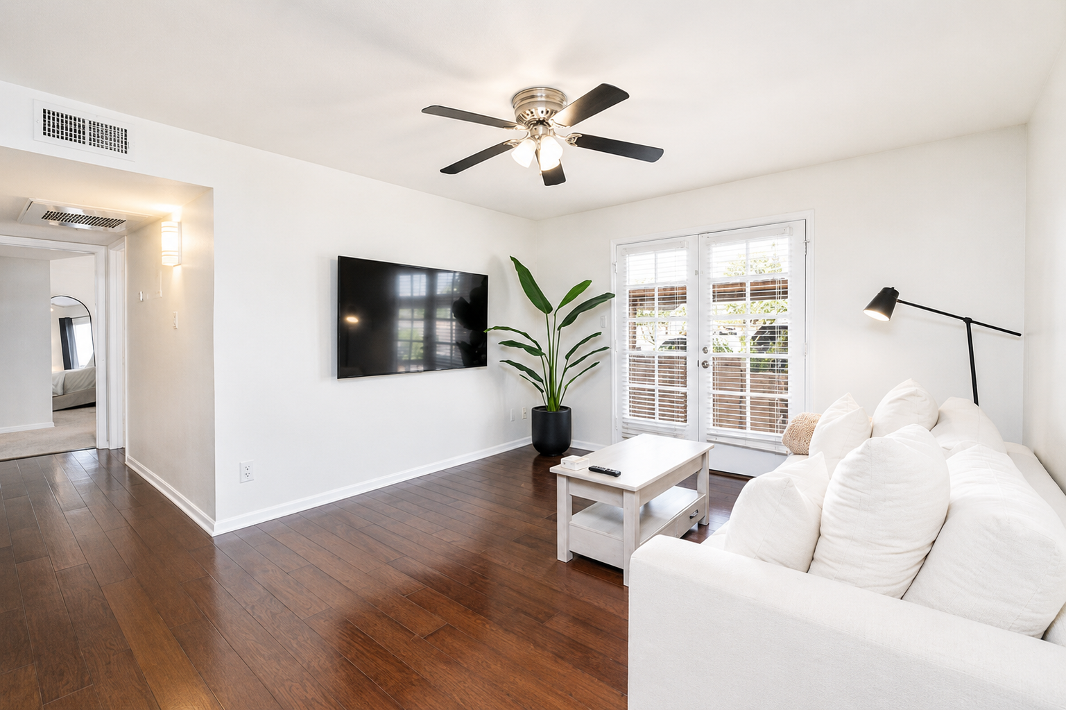 Relax indoors with a bright living area, sofa seating, Smart TV, and coffee table.
