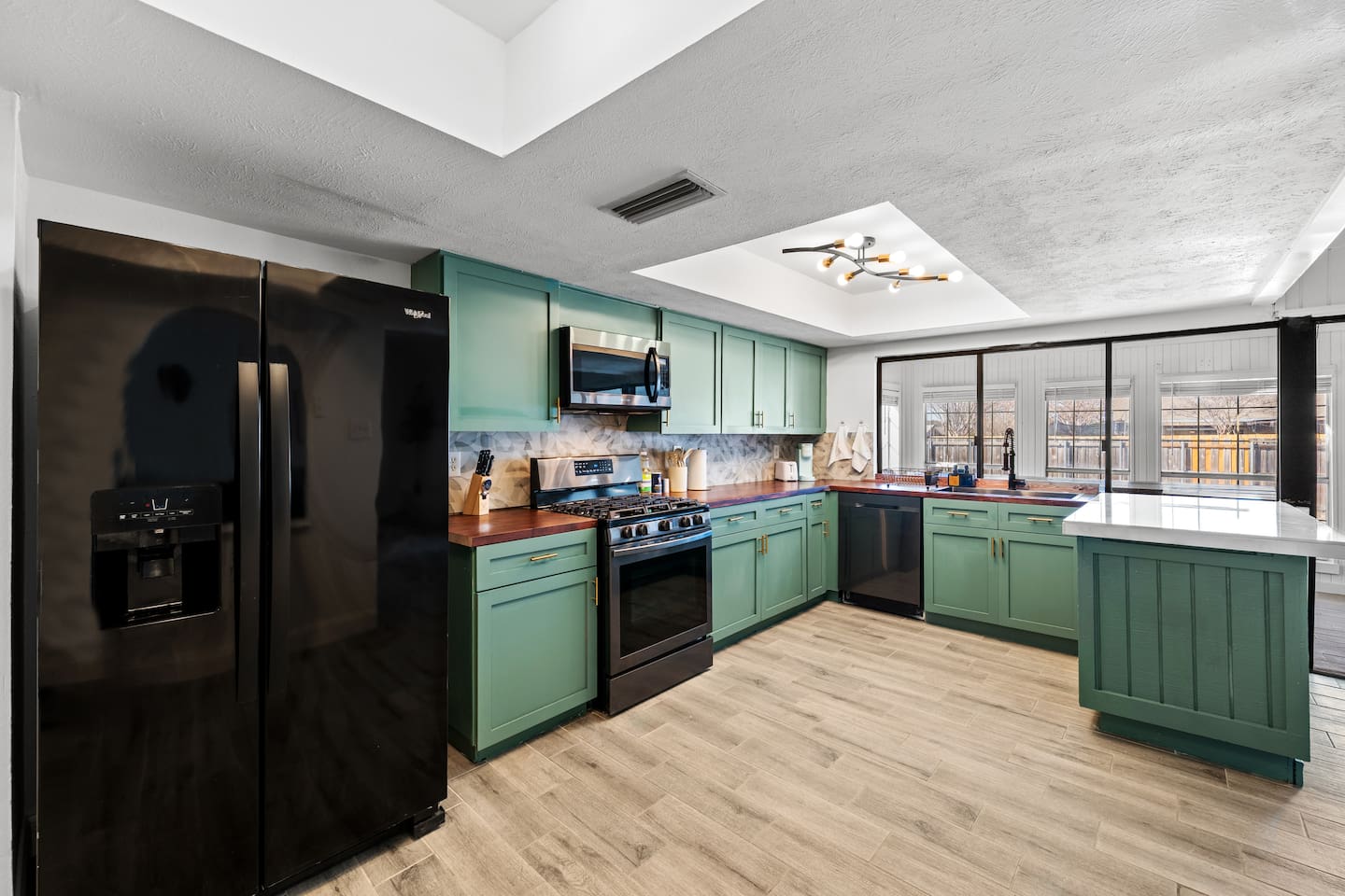 Bright, open kitchen with modern appliances and clean lines—perfect for cooking, entertaining, and staying connected to the group.