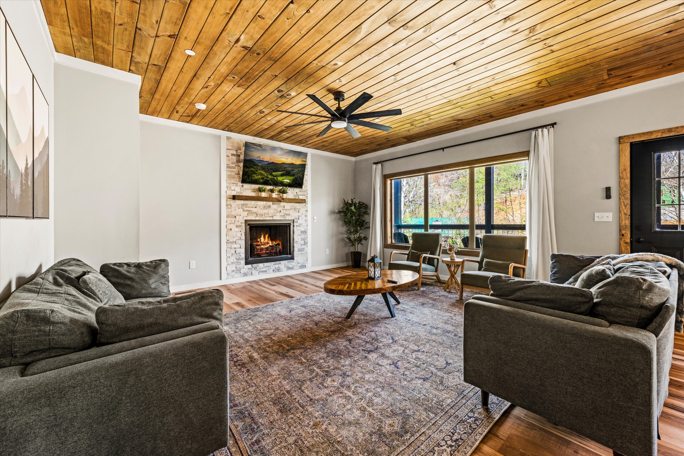 The beautifully designed living room includes a large Smart TV, gas fireplace and plenty of comfortable furniture.