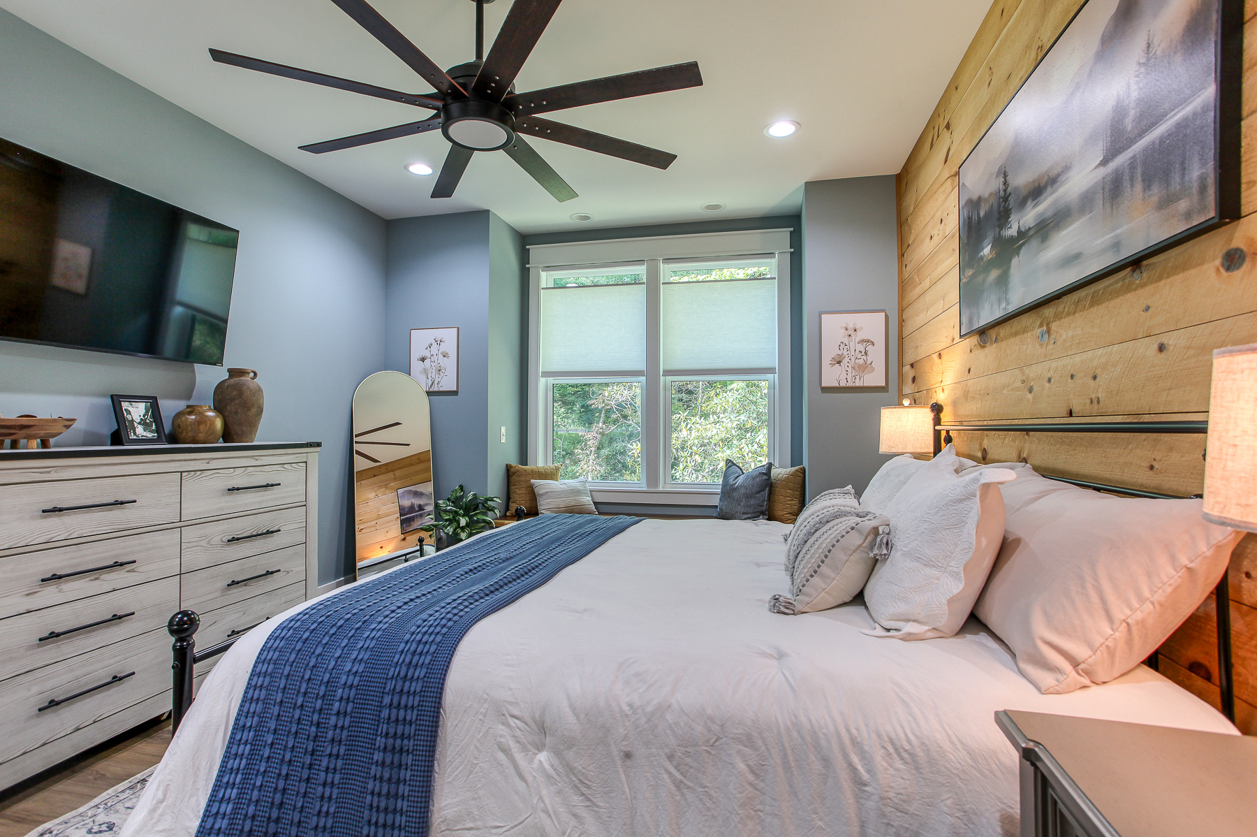 The primary bedroom at Robbin’s Nest on Snowbird Creek offers a king bed, smart TV, and dresser space to help you settle in.