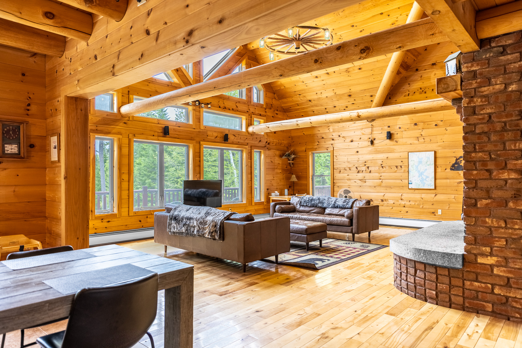 Chalet has huge logs and windows overlooking the lake giving it the true feel of lakefront retreat. Floor to ceiling wood-burning fireplace is impressive and great spot to enjoy the crackling sounds of fire while relaxing on comfortable leather couches.
